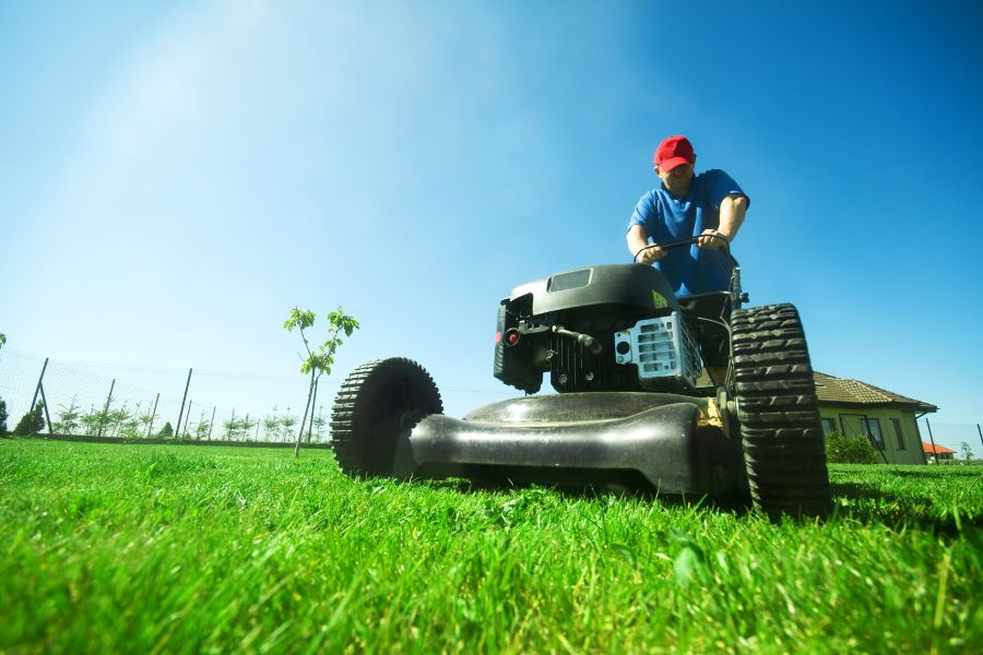 Man mowing the lawn in his garden