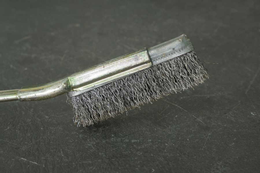 A steel wire brush on grey table
